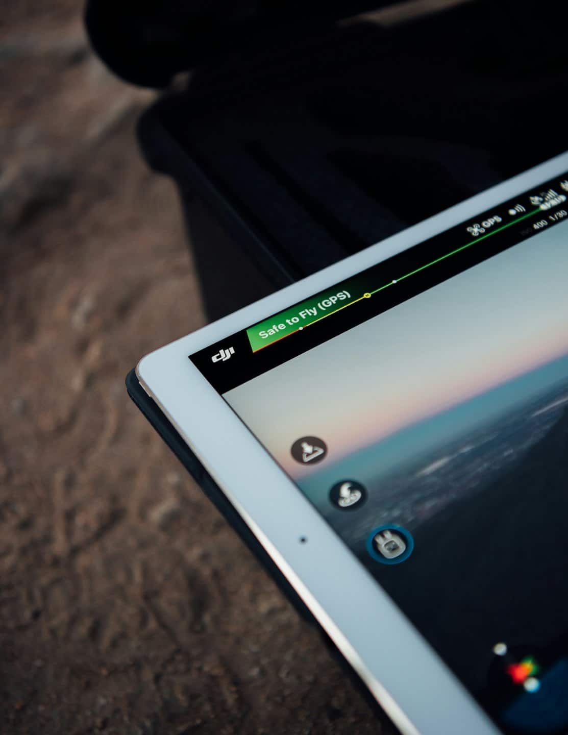 Tablet displaying drone flight control app with safe to fly status.