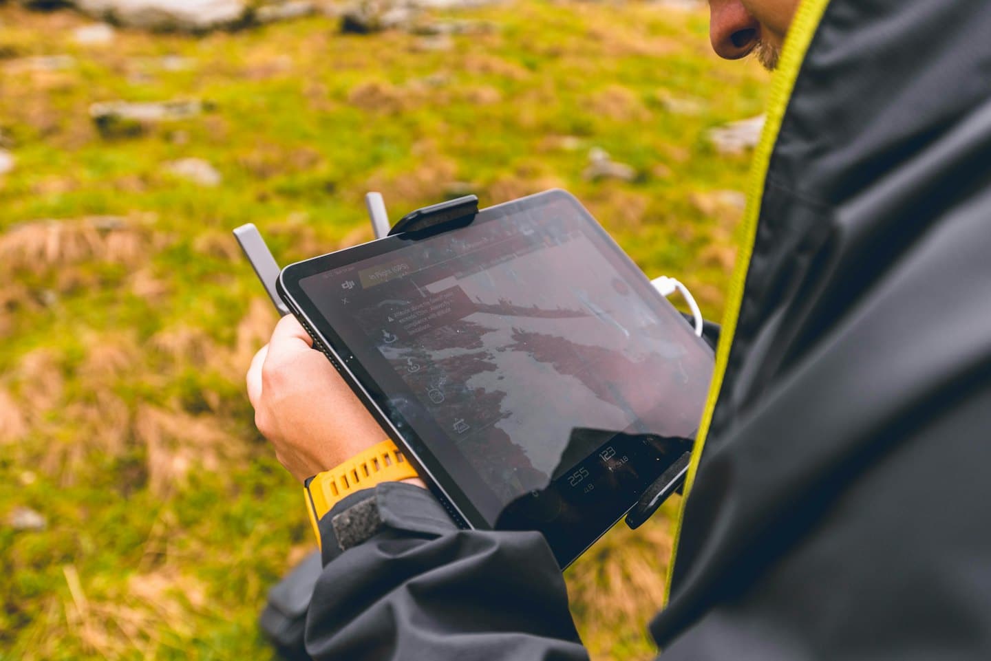 Person operating a drone controller with an error message displayed.